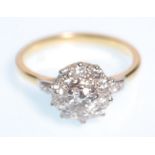 An 18ct gold  and diamond cluster ring having a central brilliant cut diamond with a halo of ten