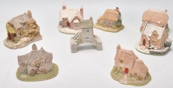 A group of eleven Lilliput lane ceramic cottages in their original boxes.