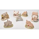 A group of eleven Lilliput lane ceramic cottages in their original boxes.