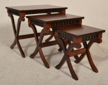 Theseira - A reproduction mahogany nest of graduating tables having carved frieze with flared tops