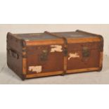 An early 20th Century travellers steamer trunk/ suitcase chest mound with wooden supports and