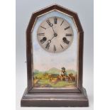 A late 19th / early 20th Century Junghans mantel clock having a wooden case with glazed door being