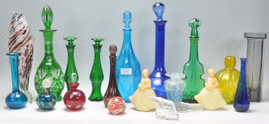 A collection of coloured studio glass to include  Mdina bottle of bulbous form with stopper, a Mdina