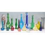 A collection of coloured studio glass to include  Mdina bottle of bulbous form with stopper, a Mdina