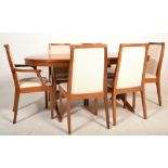 A 1970's good quality Stag teak wood extending dining table raised on splayed legs together with a