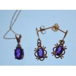 A 9ct gold pendant necklace having a fine link chain with a pendant set with a oval cut purple stone