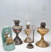 A mixed group of vintage oil lamps dating from the 19th Century to include a wall hanging example
