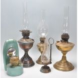 A mixed group of vintage oil lamps dating from the 19th Century to include a wall hanging example