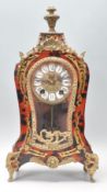 A 20th Century Walt rococo style faux tortoise shell mantel clock of waisted from being raised on