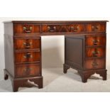 An Antique Georgian style mahogany twin pedestal desk having gilt tooled leather skiver with