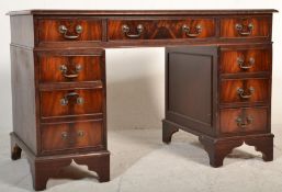 An Antique Georgian style mahogany twin pedestal desk having gilt tooled leather skiver with