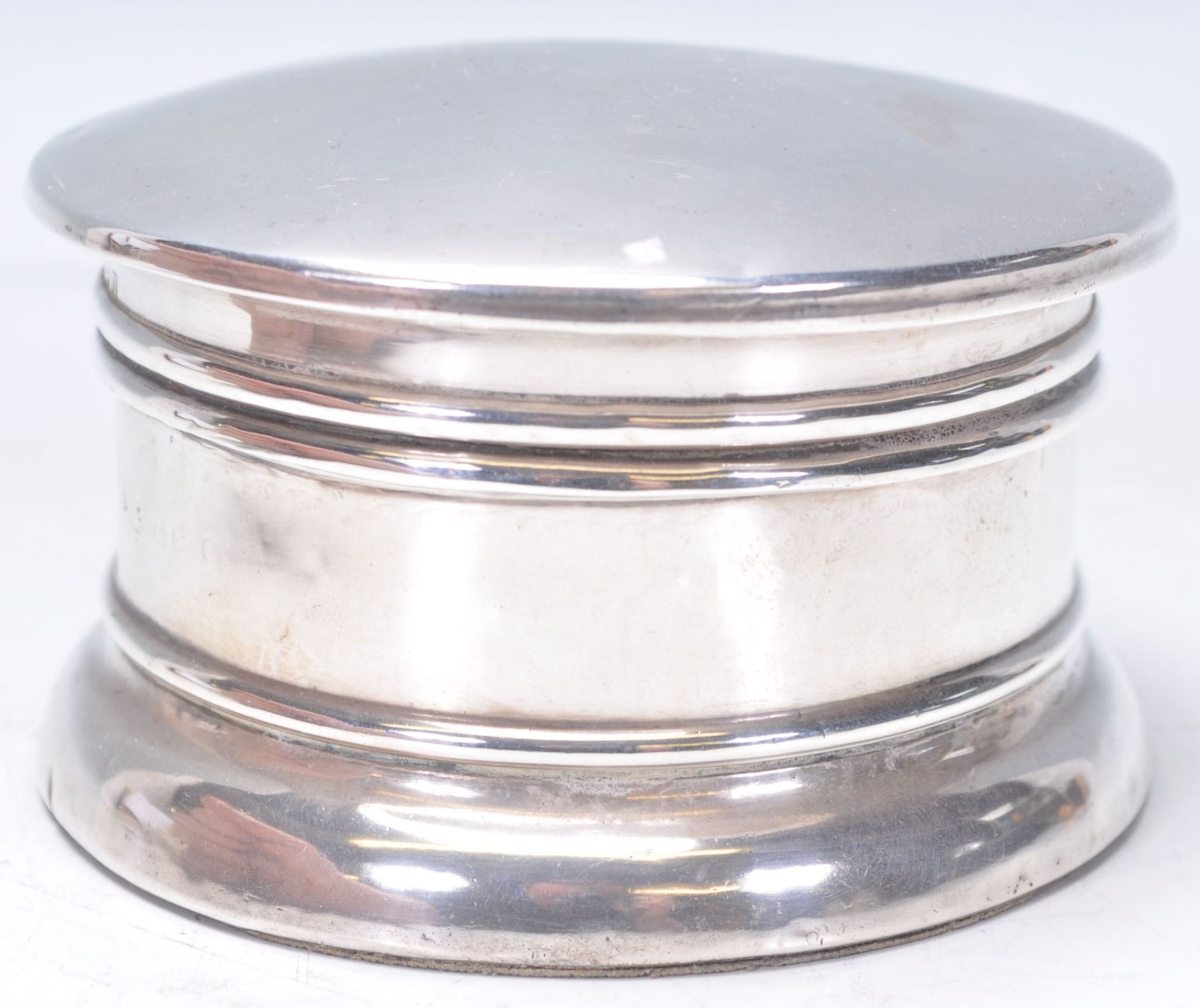 A large early 20th Century silver hallmarked powder pot / table compact of cylindrical form having a