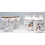 A collection of reproduction ceramic apothecary jars to of cylindrical form having pointed lids with