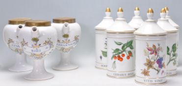 A collection of reproduction ceramic apothecary jars to of cylindrical form having pointed lids with