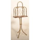 A late 19th / early 20th Century mahogany and brass magazine rack raised on a a brass tripod