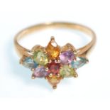 A hallmarked 9ct gold ladies dress ring set with a cluster of tear drop cut coloured stones. Bears