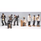 A collection of vintage ceramic figurines in the form of jazz players, complete with instruments, to