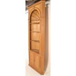 A substantial contemporary pine niche / corner cupboard decorated with a dentil cornice above a