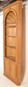 A substantial contemporary pine niche / corner cupboard decorated with a dentil cornice above a