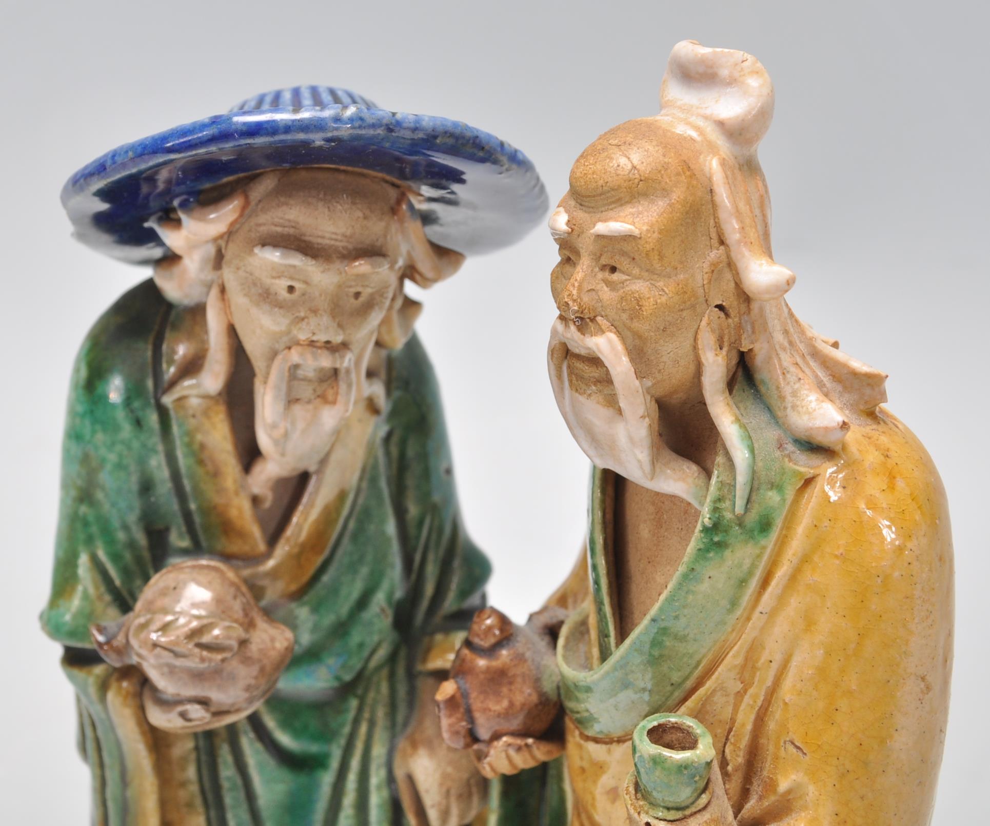 A pair of 1920's Chinese export Ming Dynasty style ceramic figurines in the form of two men glazed - Image 7 of 7