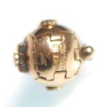 A hallmarked 9ct gold masonic ball pendant unfolding into six sections with geometric decoration and