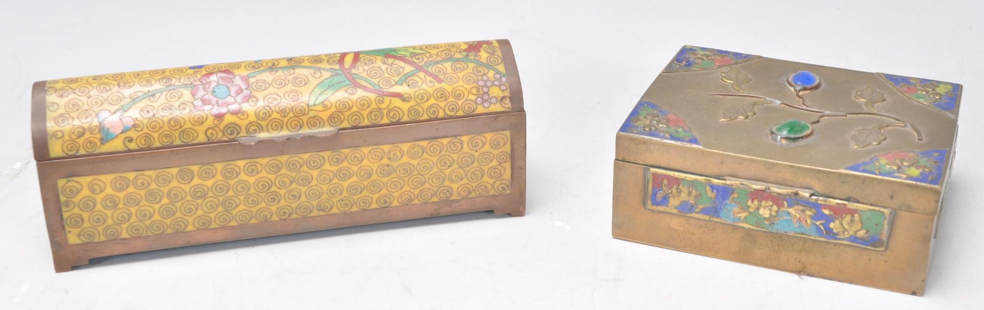 A Chinese brass stamp case of rectangular form set with inset coloured stone orbs with enamel