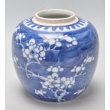 A late 19th / early 20th Century Chinese ginger jar of bulbous form being hand painted in blue an
