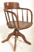 An early 20th Century captains desk oak industrial factory swivel chair raised on four swivel