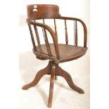 An early 20th Century captains desk oak industrial factory swivel chair raised on four swivel