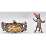 A charming late 19th Century small cast figure of three cats / kittens climbing into a metal woven