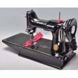 A vintage 20th Century Singer Featherweight convertible portable sewing machine model number 221k