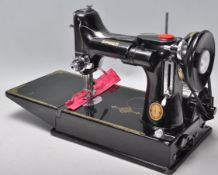 A vintage 20th Century Singer Featherweight convertible portable sewing machine model number 221k
