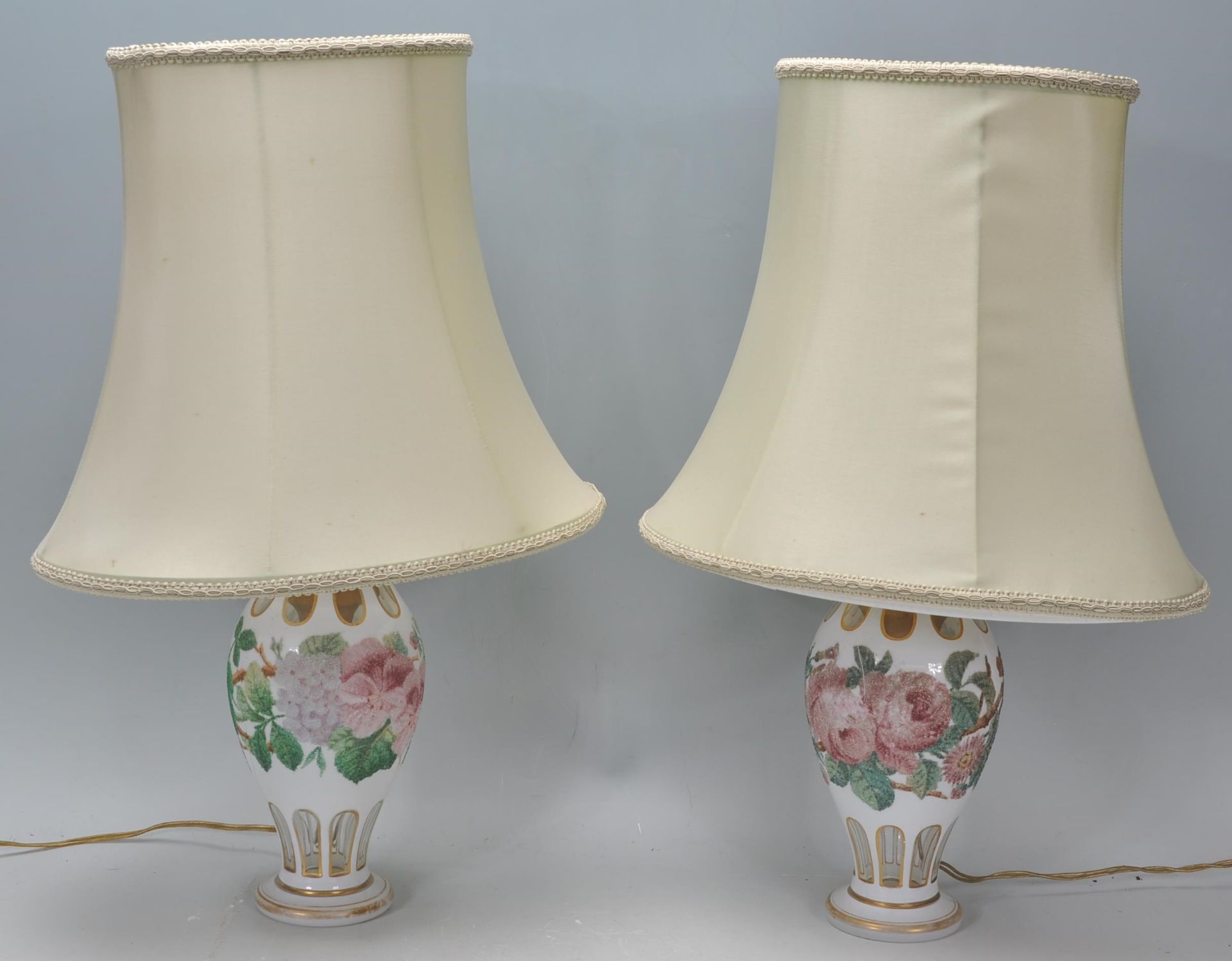 A pair of 20th Century glass table lamps of bulbous tapering form, having faceted decoration to