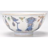 A 19th Century Chinese poly chrome footed bowl being hand painted with precious objects / the 100