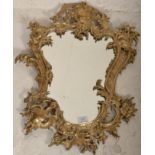 A late 19th / early 20th Century Rococo style gilt metal framed wall mirror. The frame with