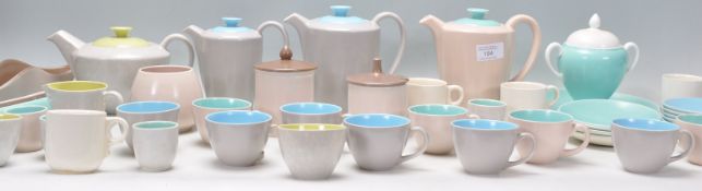 A collection of vintage Poole pottery to include coffee pots, tea pot, cups and saucers, sugar bowls