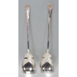 A set of Walker and Hall silver servers having scrolled design handles with shell terminals.