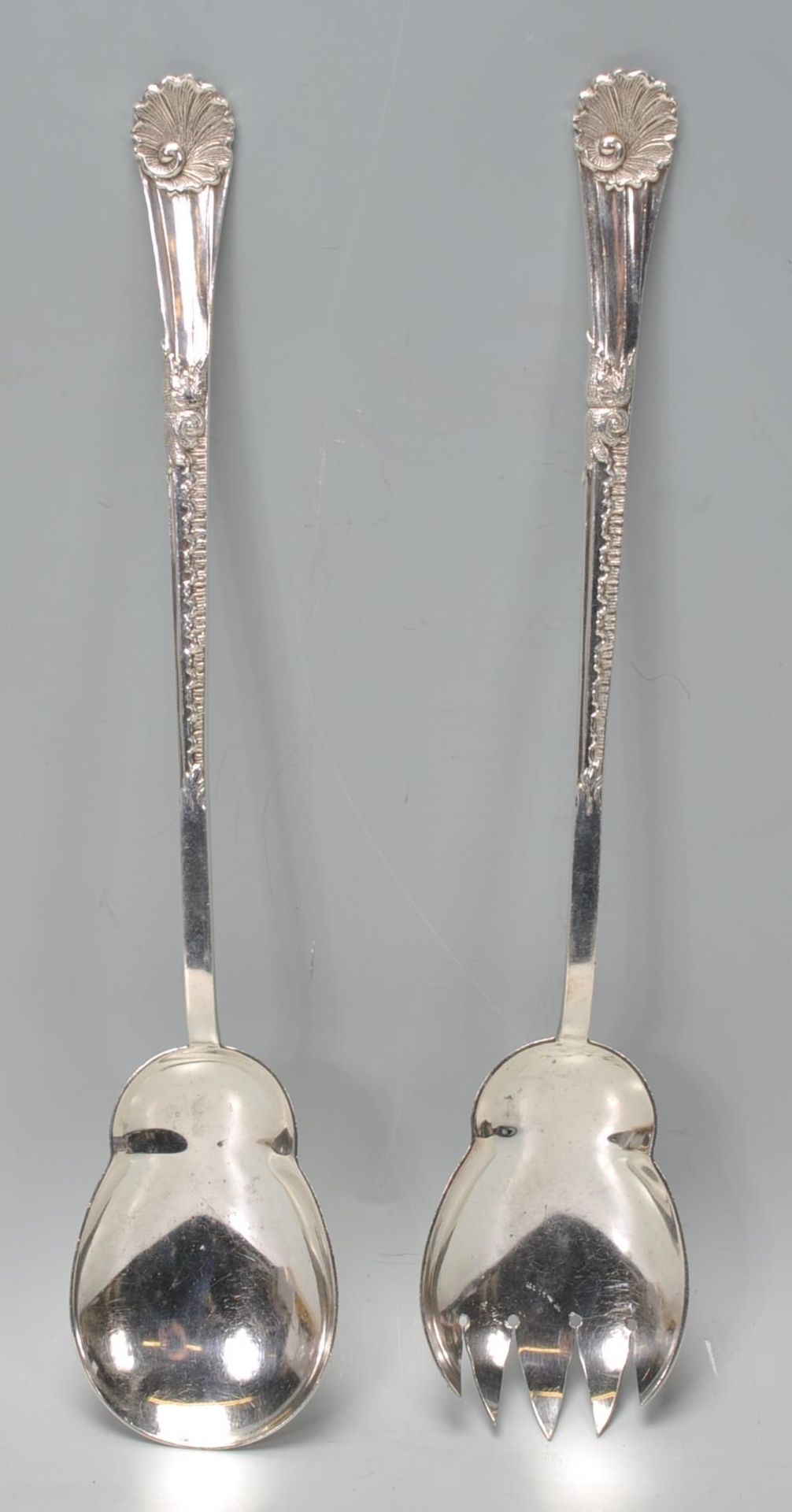 A set of Walker and Hall silver servers having scrolled design handles with shell terminals.