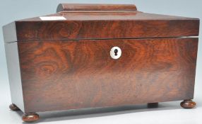 A 19th Century Victorian mahogany tea caddy of sarcophagus raised on bun feet with mother of pearl
