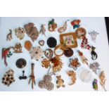 A collection of vintage brooches to include two scottish grouse claw brooches, a bird brooch with an