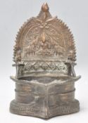 A good late 19th Century Eastern bronze buddha stand with embossed floral and elephant decoration to