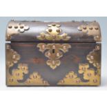 A Victorian 19th century coromandel dome top casket caddy with good armorial oversized brass strap