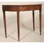 A 19th century George III mahogany card / games table being raised on spiral candy twist legs with