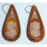 A pair of Victorian gold cameo earrings of tear drop shape, the conch shell panels carved with