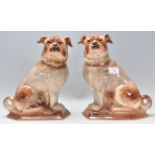 A pair of 19th Century Victorian ceramic pug type dogs moulded in a seated position with gilt