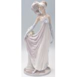 A Lladro porcelain figurine in the form of a 1920's flapper girl modelled with a feather headdress