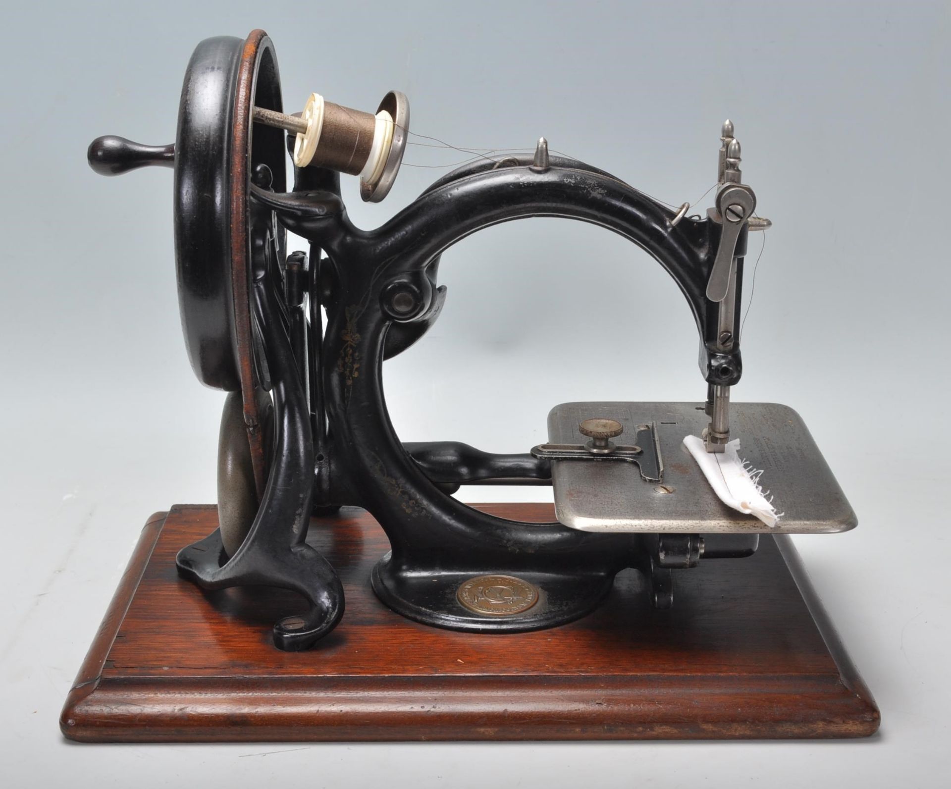 A good pine cased late 19th / early 20th Century Willcox & Gibbs sewing machine finished in black