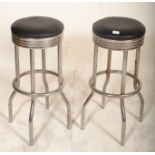 A pair of vintage retro 20th Century chrome bar / breakfast stools with black leatherette seat and