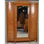 A good 19th century continental burr walnut triple armoire wardrobe having breakfront mirror door
