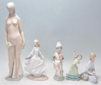 A collection of Lladro figurines to include a flamenco dancer girl, a Valencian girl with flowers